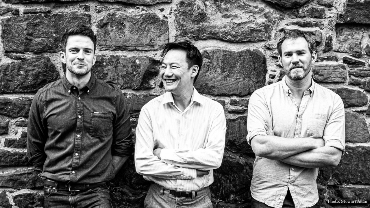 A black and white photo of Jonny McMillan (Distillery Manager), Aaron Chan (Chairman), Angus MacRaild (Whisky Maker). - Photo credit: Stewart Allan
